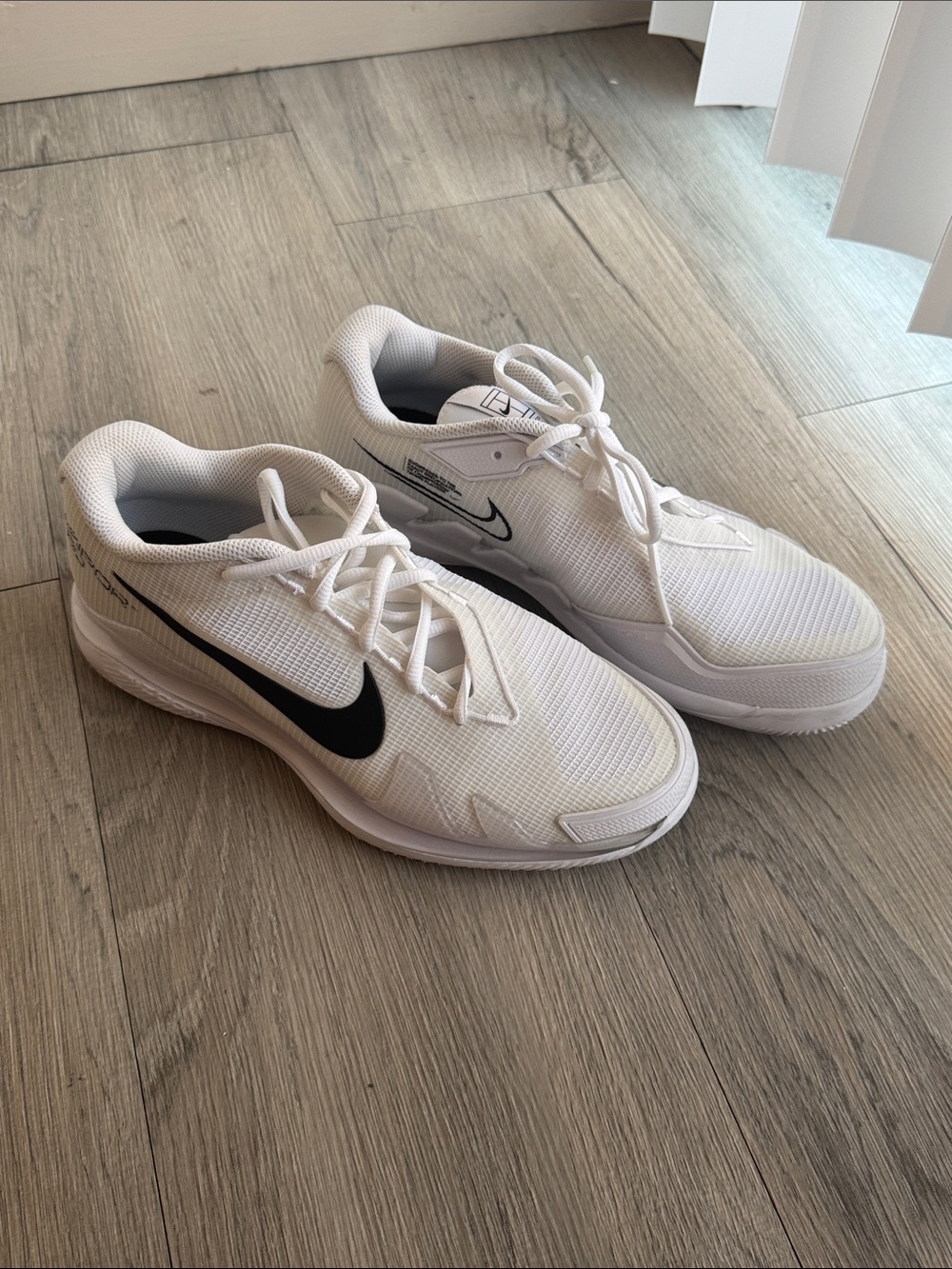 Nike White Athletic Shoes with Black Swoosh - Women's